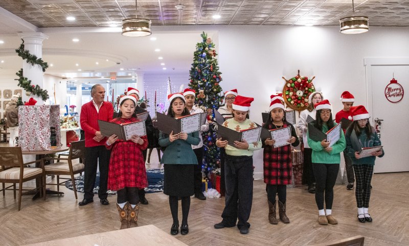 The Lodge at Historic Lewes hosts carolers serenading the residents.